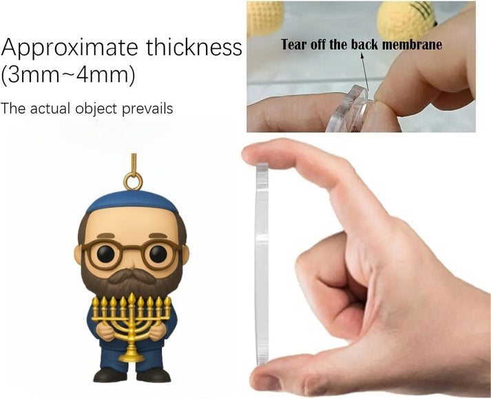 Hand holding a clear plastic strip next to a figurine with a menorah, showing the thickness measurement.