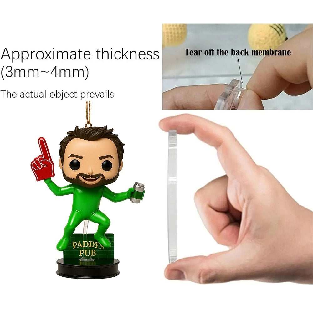 Green figurine with a red finger pointing, held by a hand with a clear plastic strip, labeled 'Paddy's Pub'.