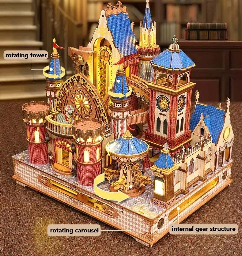 assembled Annecy Castle model with rotating tower, carousel, and internal gear structure on a wooden surface.