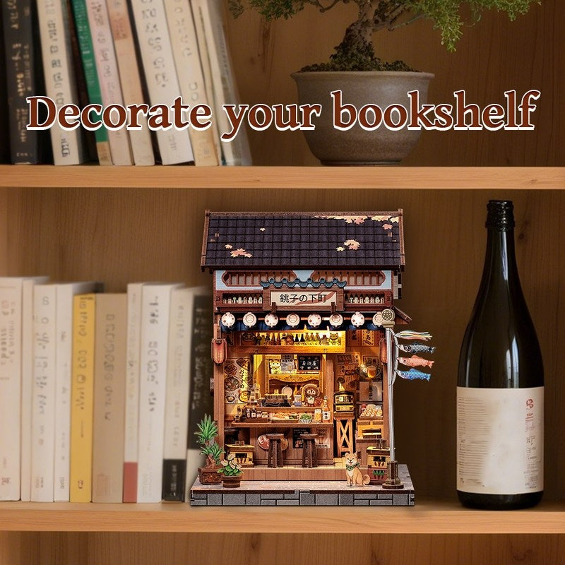 Miniature Book Nook of a Japanese Izakaya building on a bookshelf with books