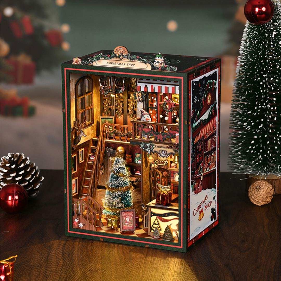 Decorative Christmas scene with a detailed model of a store and Christmas tree on a festive background.