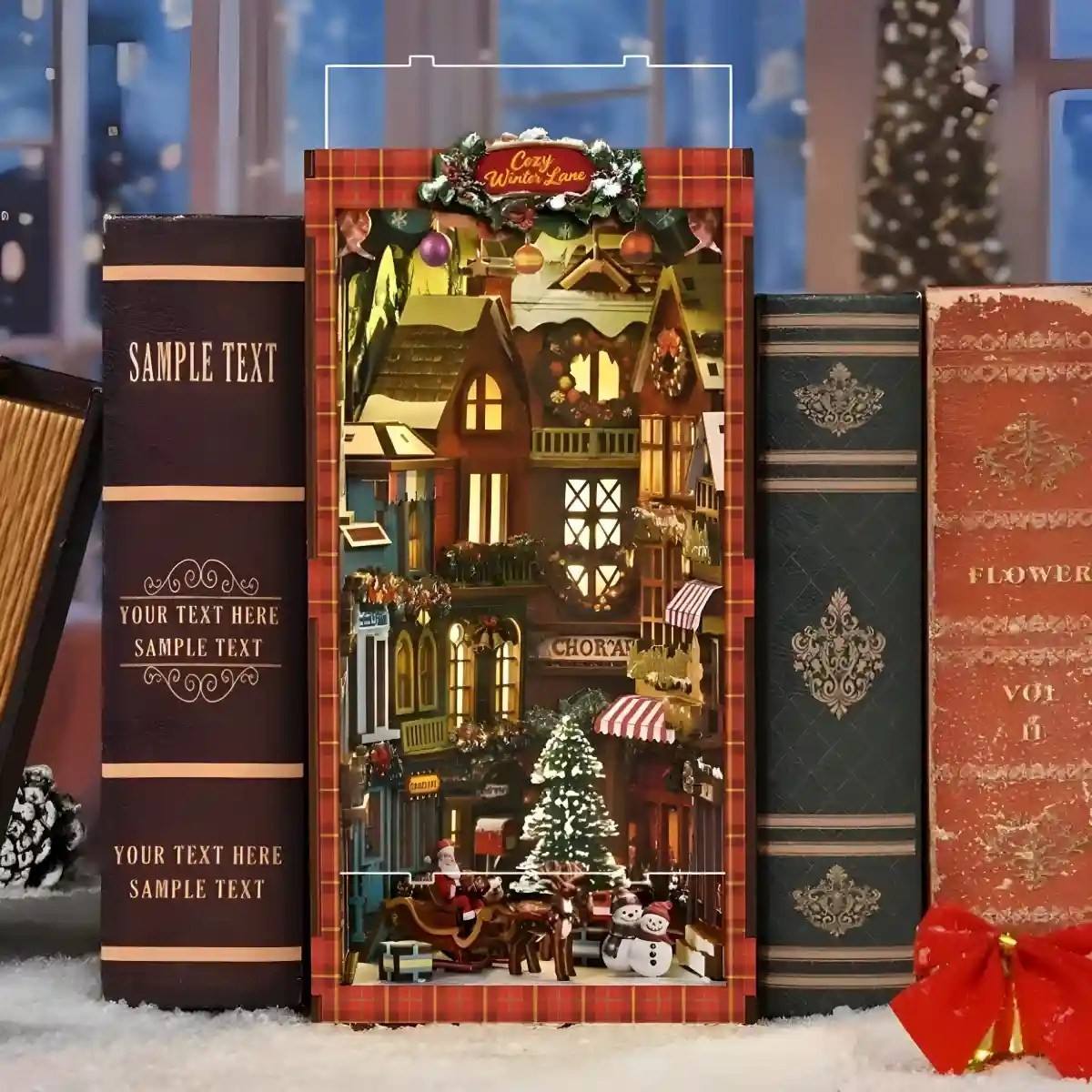 Decorative bookshelf with Christmas-themed miniature village scene, surrounded by books and a snowy background.