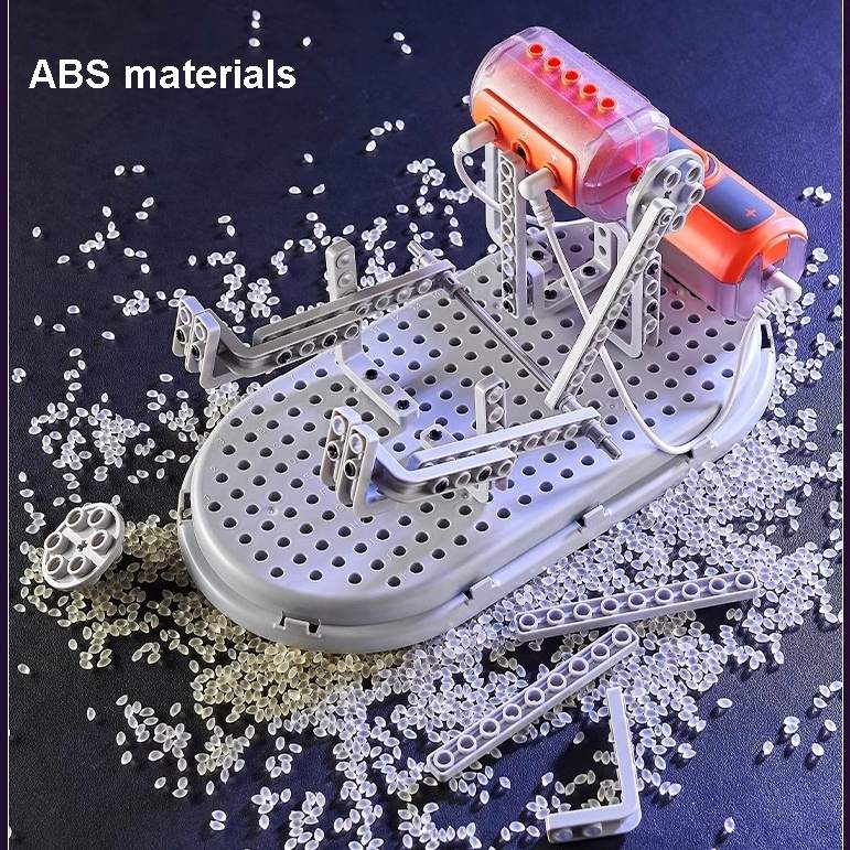 Model of a vehicle made from ABS materials with scattered ABS beads on a dark background