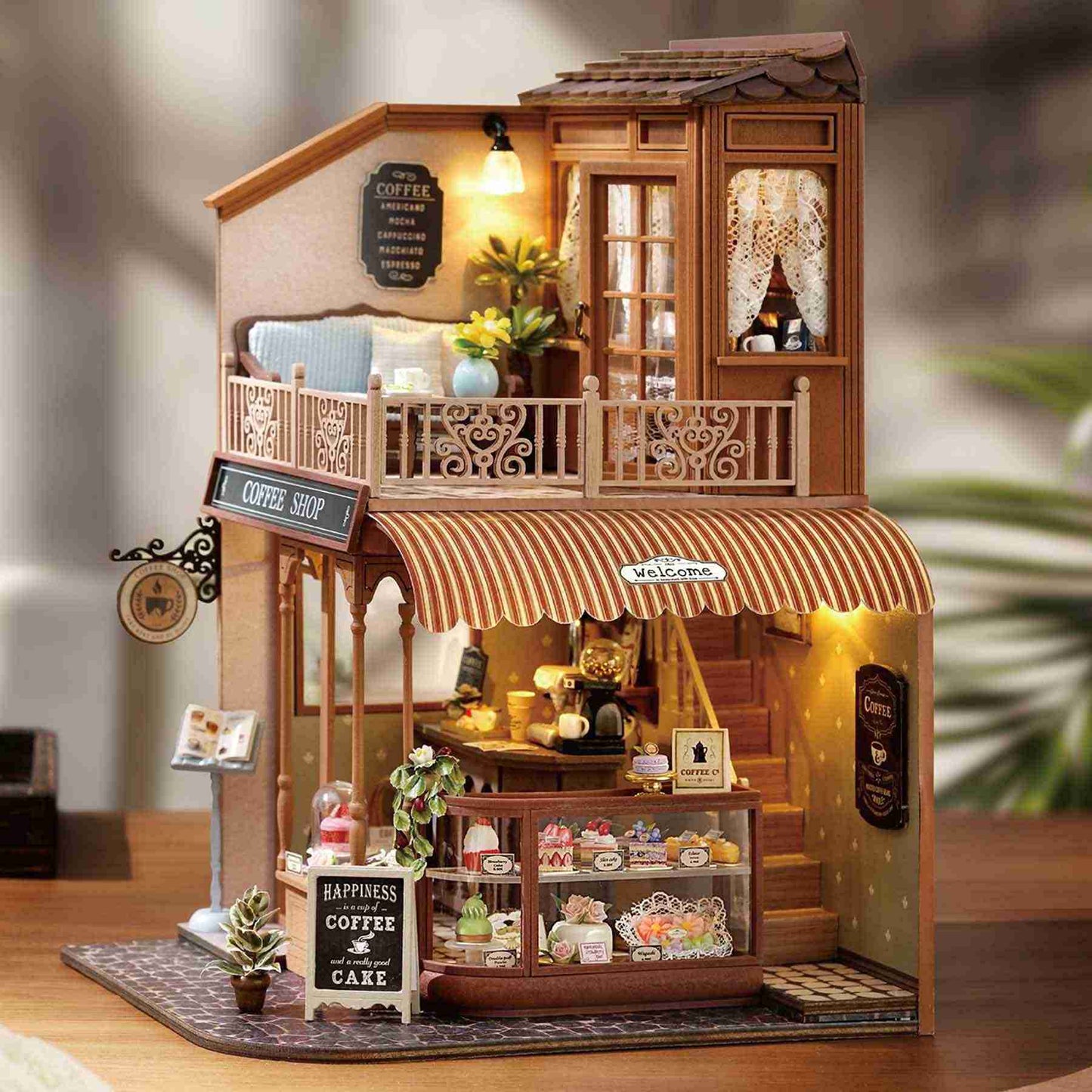 Miniature model of a coffee shop with detailed interior and exterior elements, and warm Led lights on