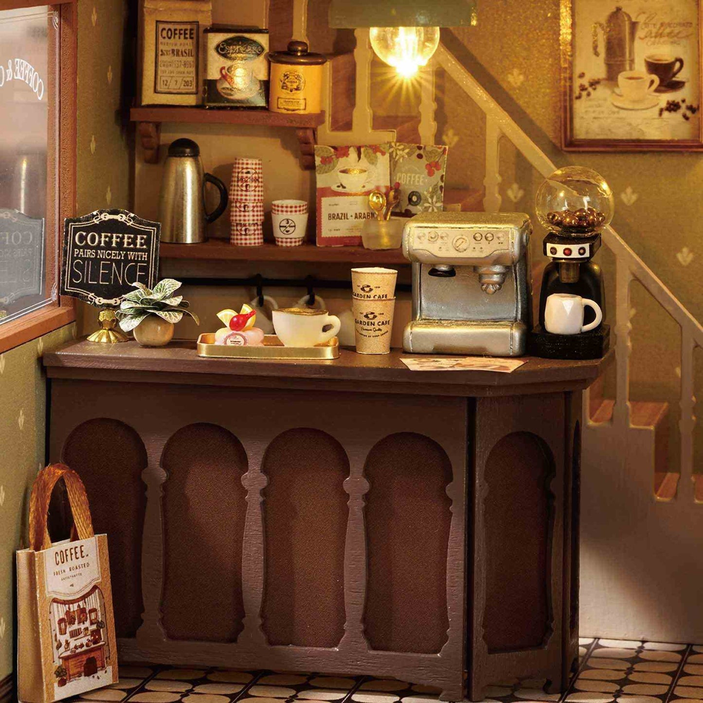 Miniature coffee station with coffee machine, cups, and decor in a cozy setting.