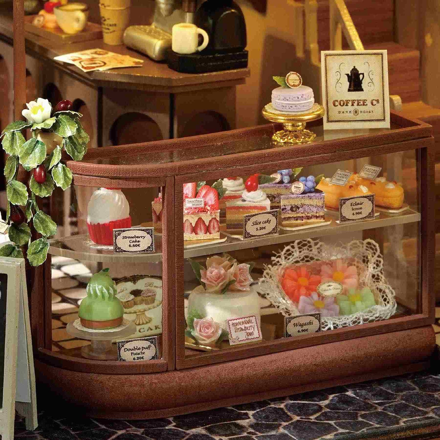 Miniature bakery display case with various pastries in a cozy setting