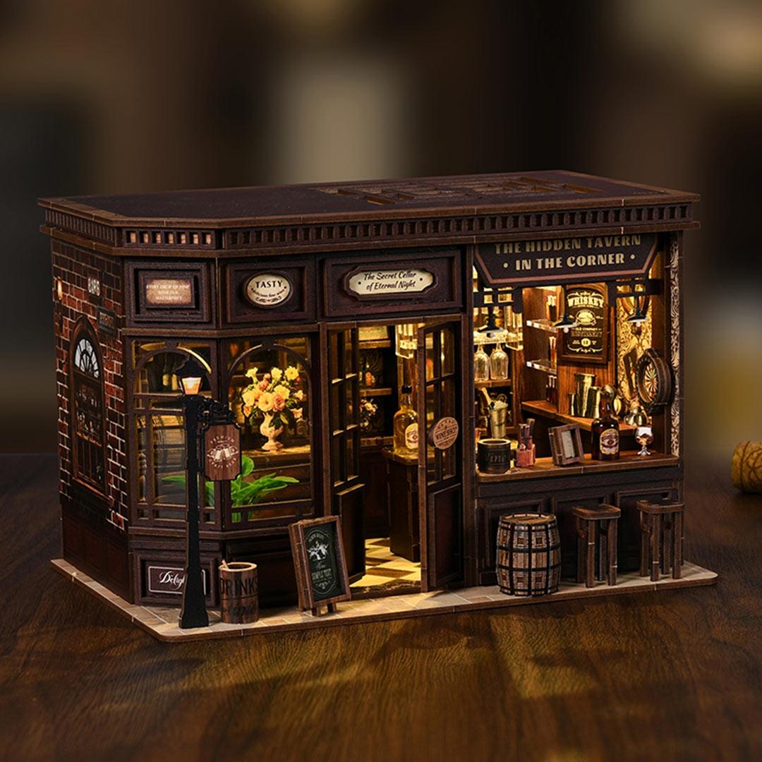 Miniature model of a bar with detailed interior on a dark background