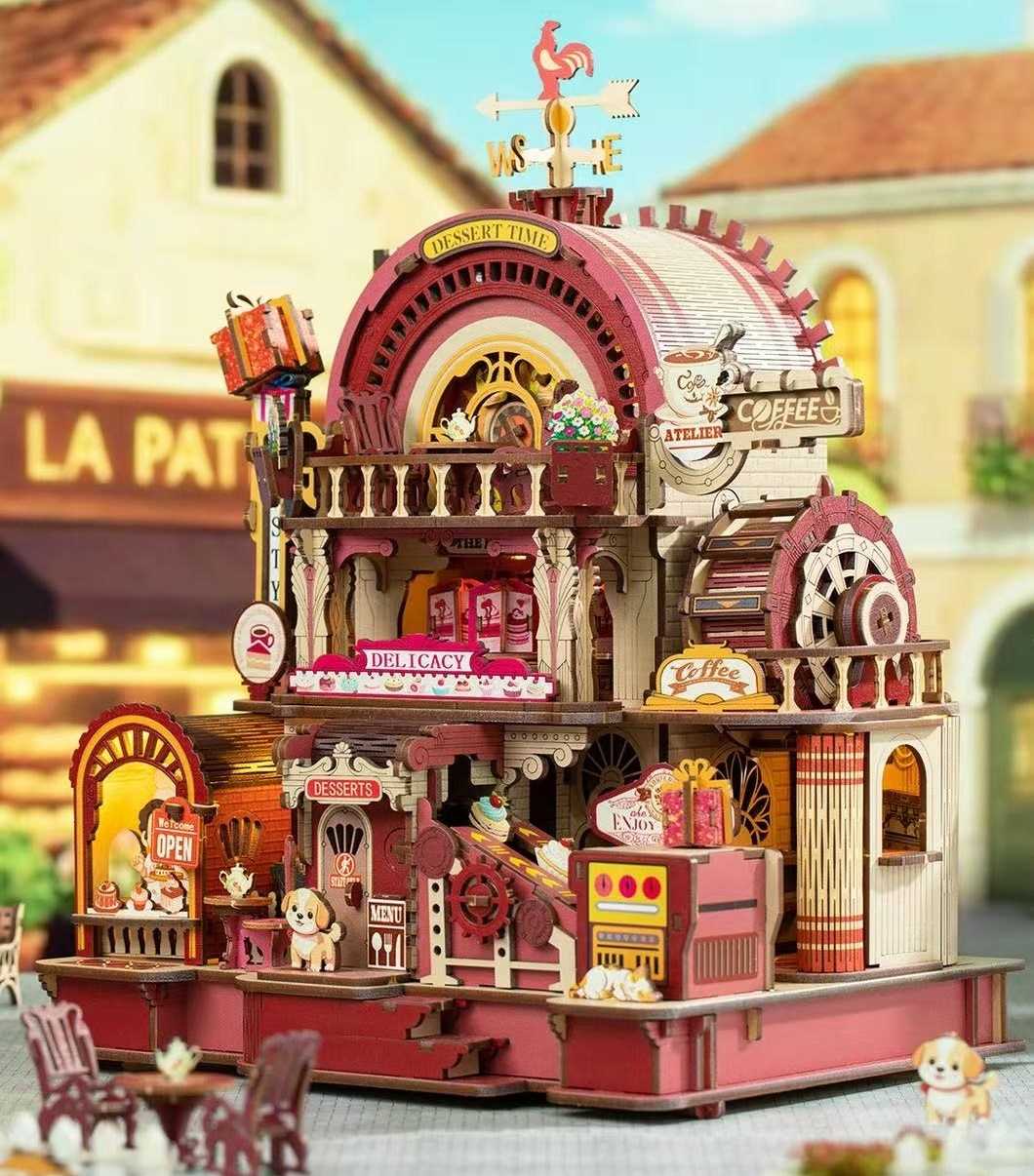 Detailed wooden toy model of a vintage-style cafe with various mechanical elements and signs.
