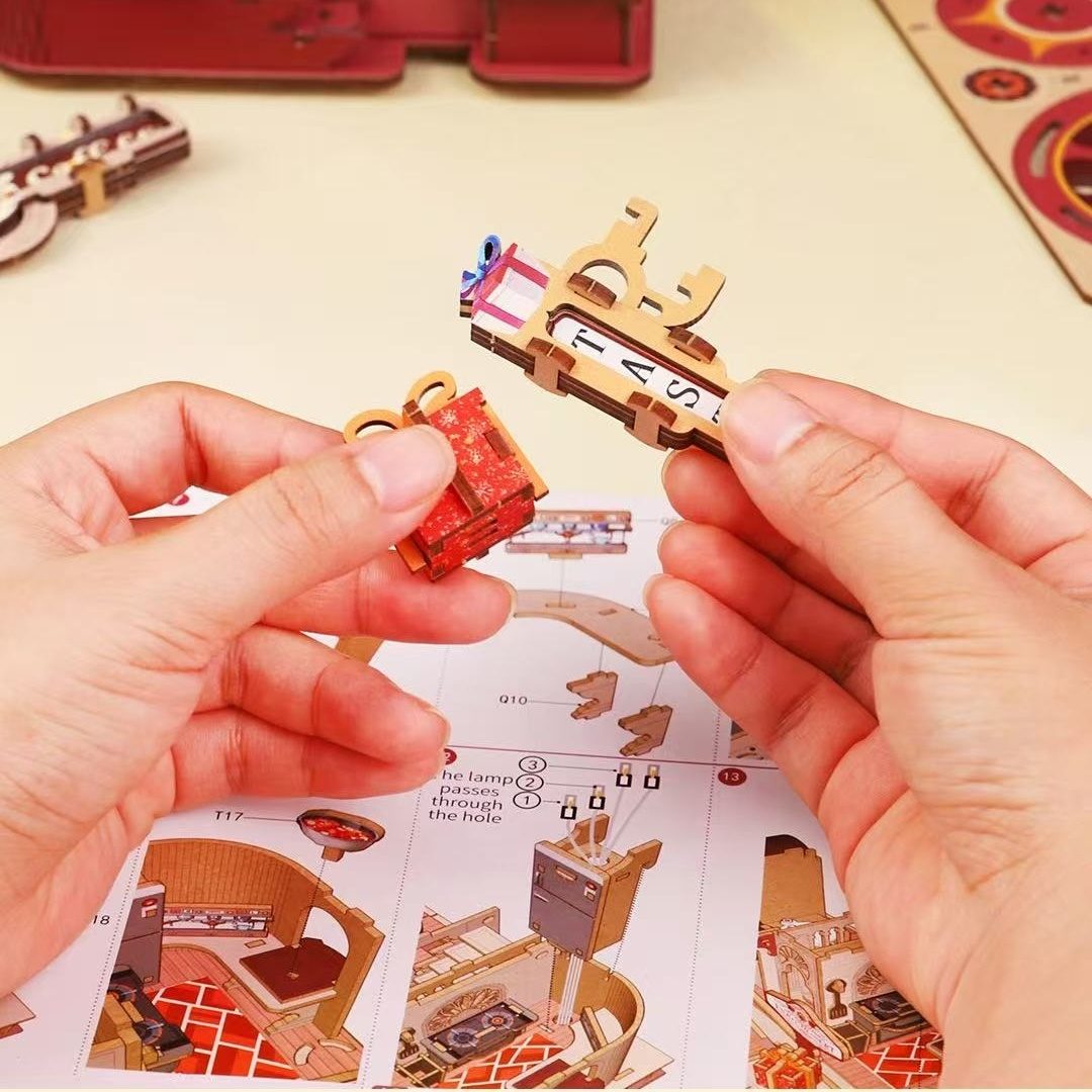 Hands assembling a small wooden model with a puzzle piece in the background