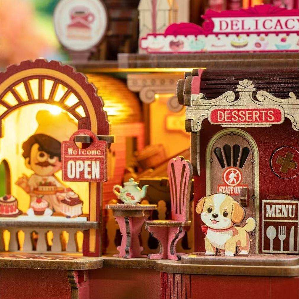 Miniature dessert pickup counter and entrance with a dog figurine and 'Open' sign, featuring a warm color palette.