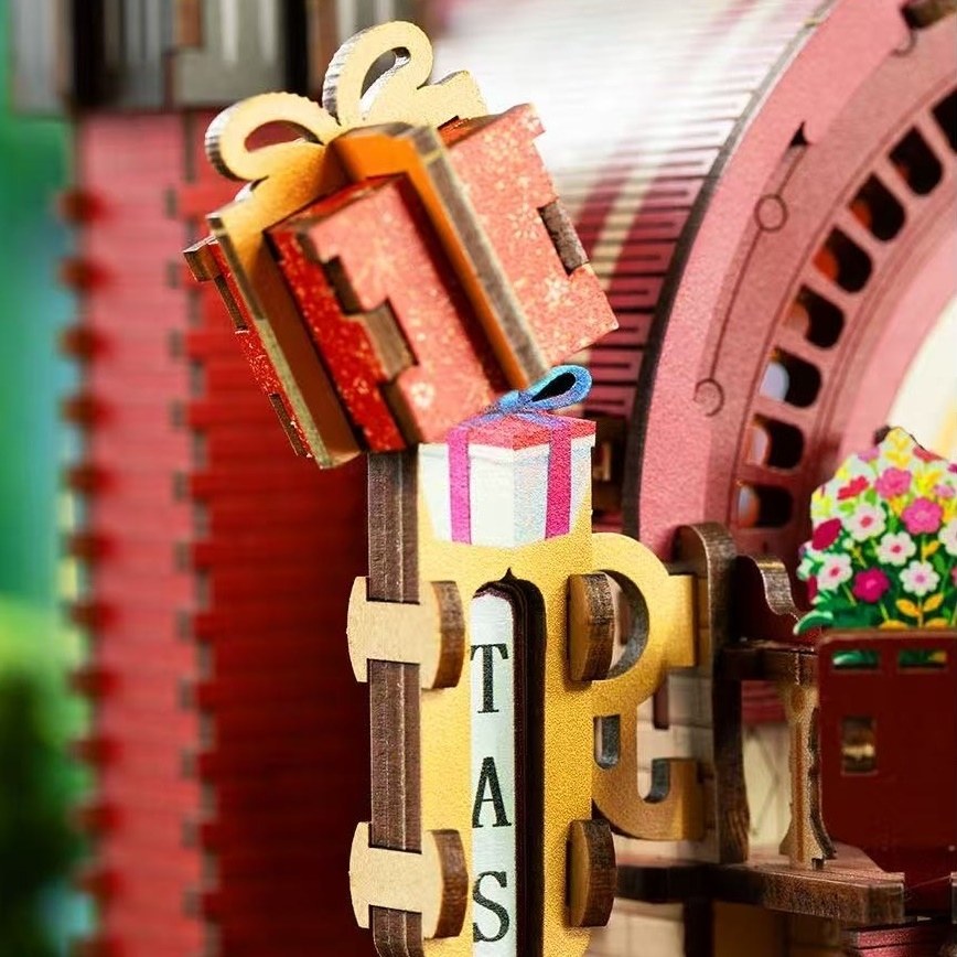 Wooden puzzle with gears and decorative elements, including a gift box and flowers.