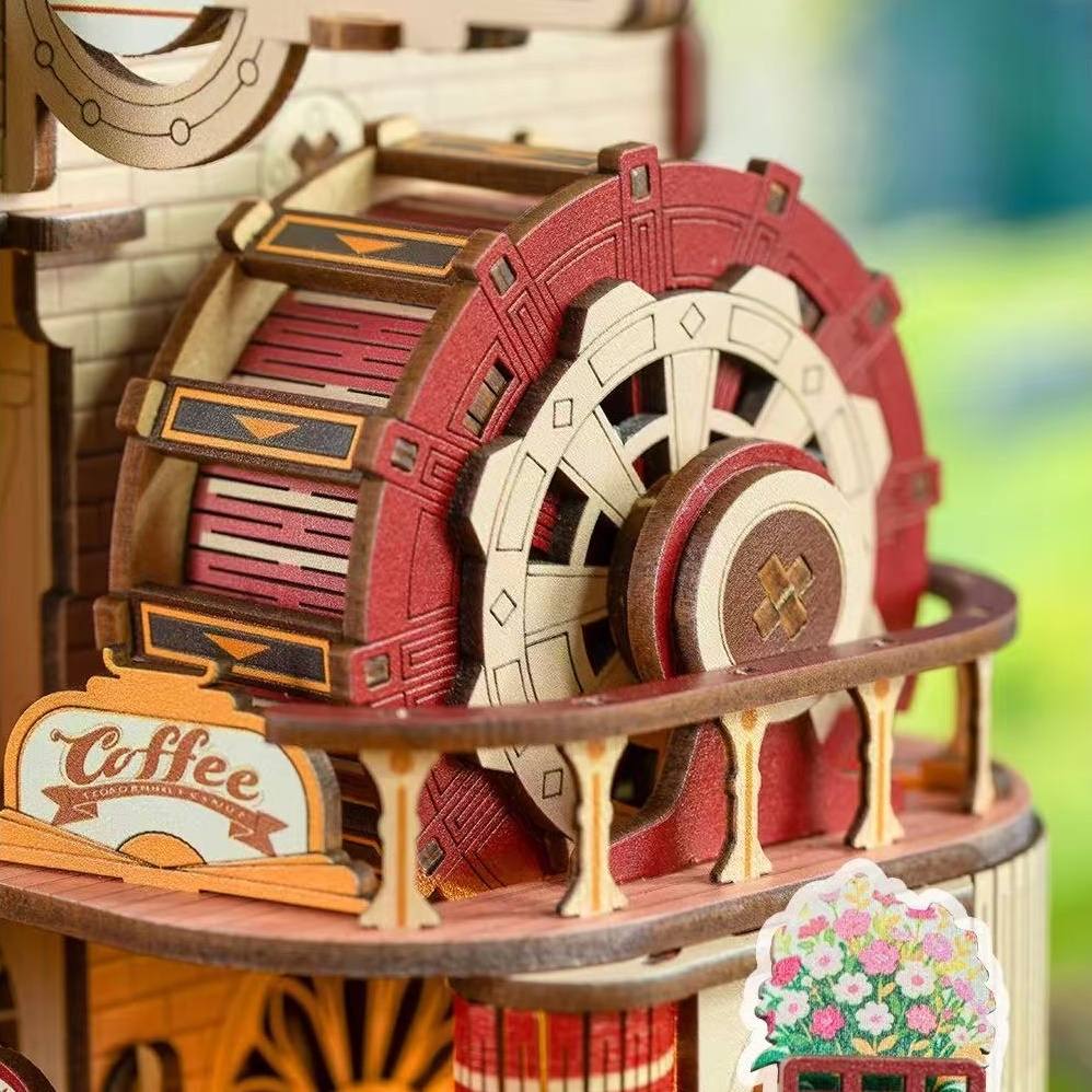 Wooden mechanical model with gears and a 'Coffee' sign on a blurred background