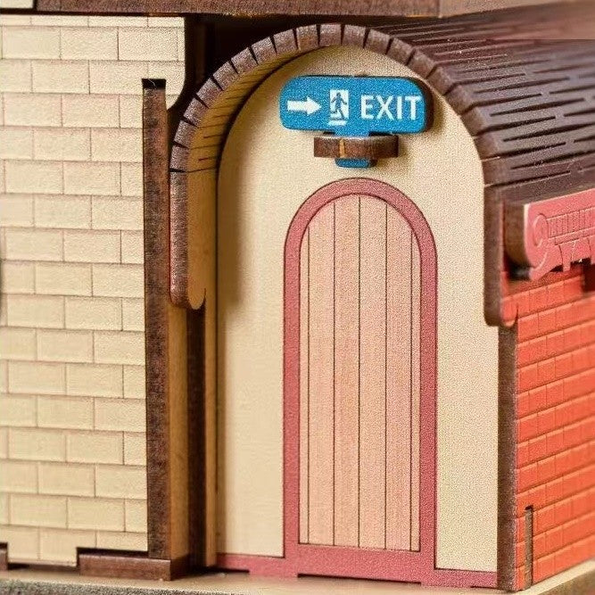 Model of a building entrance with an 'EXIT' sign above a wooden door.