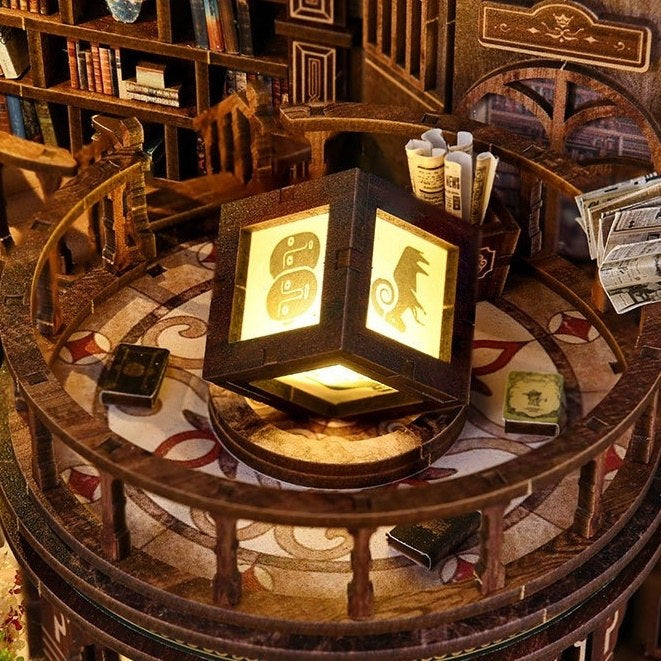 Wooden puzzle box with glowing panels on the balcony in Dreamy Book Hall Miniature House