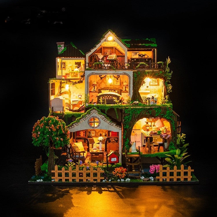 image displaying the assembled 
 and lit Fairy Tale Forest Miniature House in nighttime, casting warm cozy light