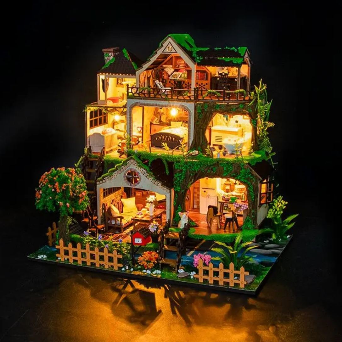 assembled and lit Fairy Tale Forest Miniature House on table in nighttime, casting warm light