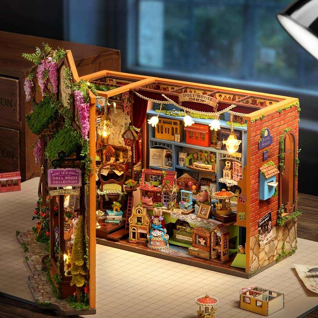 Detailed interior of a miniature dollhouse shop with various shops and decorations on a table.