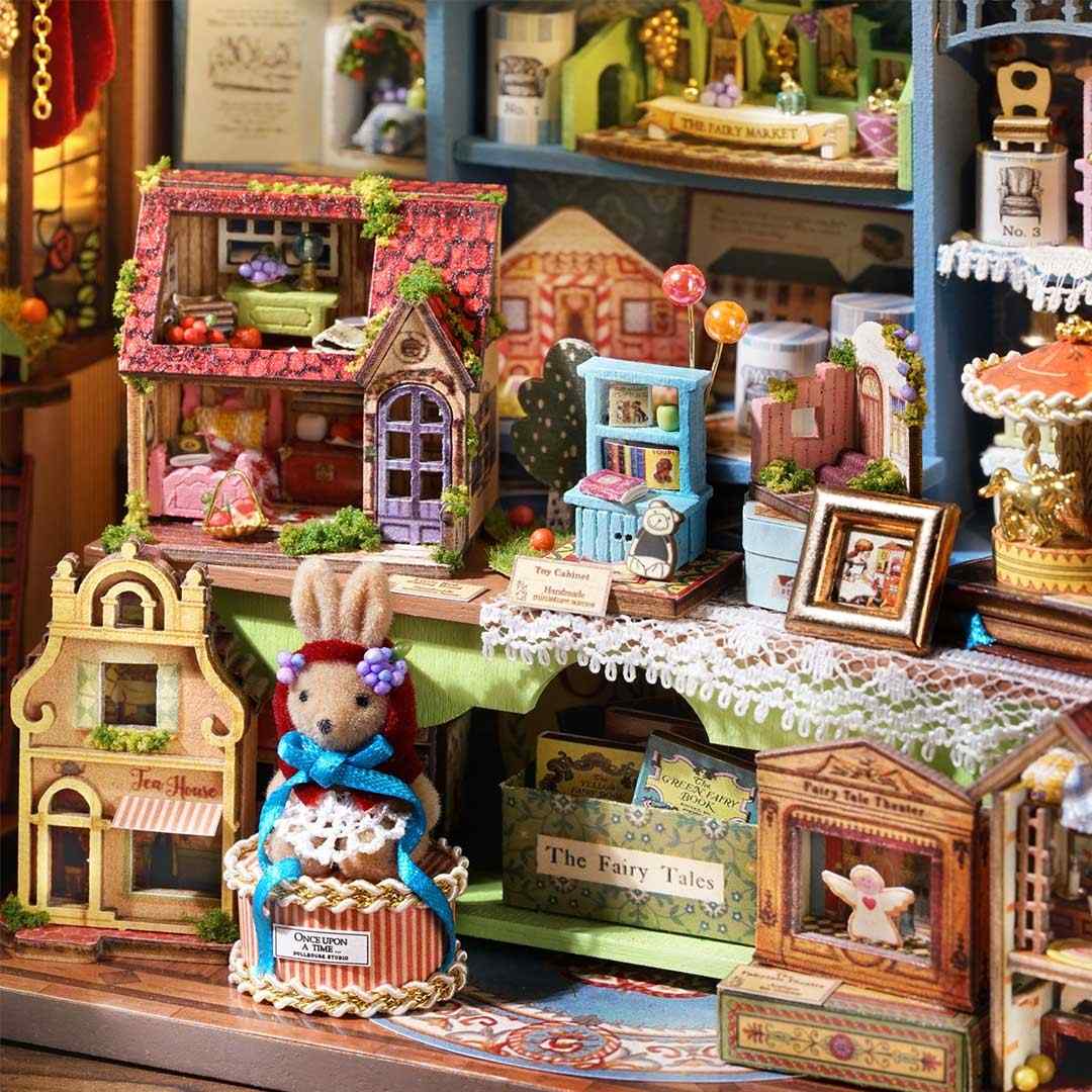 Miniature model village with detailed houses and a rabbit figure.