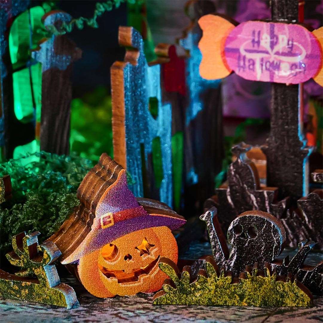Halloween-themed decorative miniature house with jack-o'-lantern, haunted house, and ghost in a darkly lit scene.