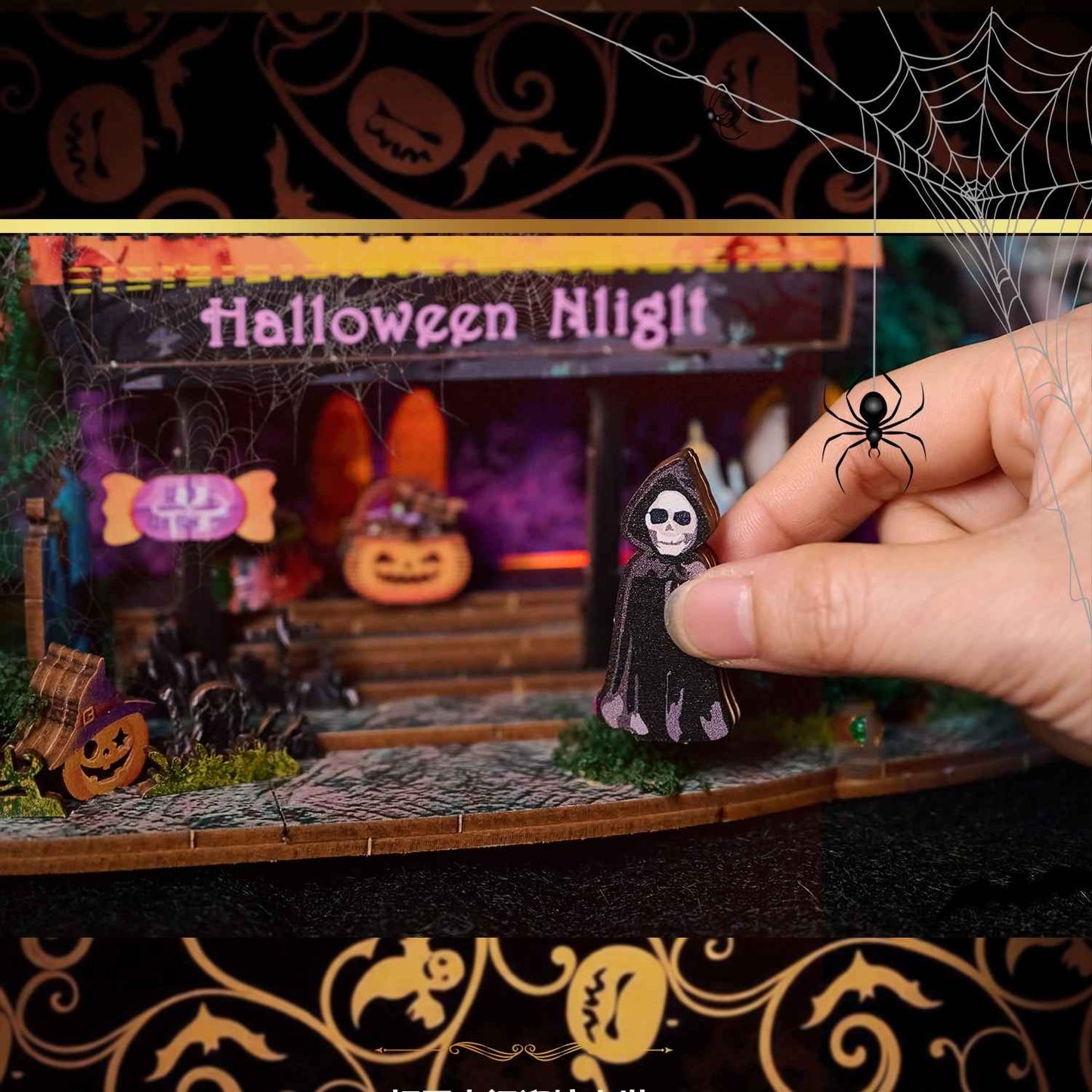 Halloween-themed diorama with a hand holding a small skeleton figure.