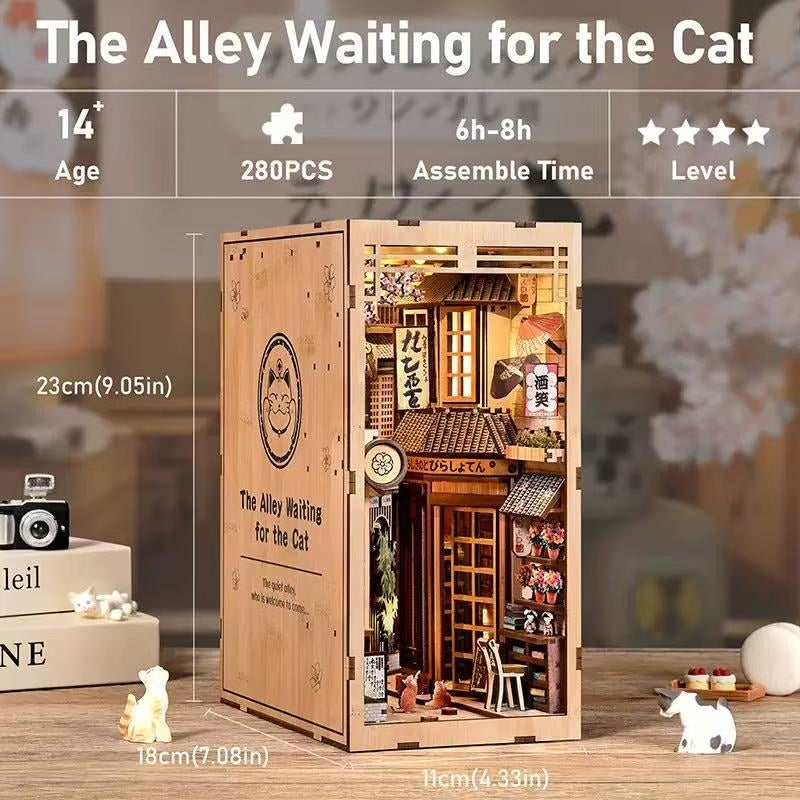 Wooden book nook model kit of a miniature town scene with 'The Alley Waiting for the Cat' branding.
