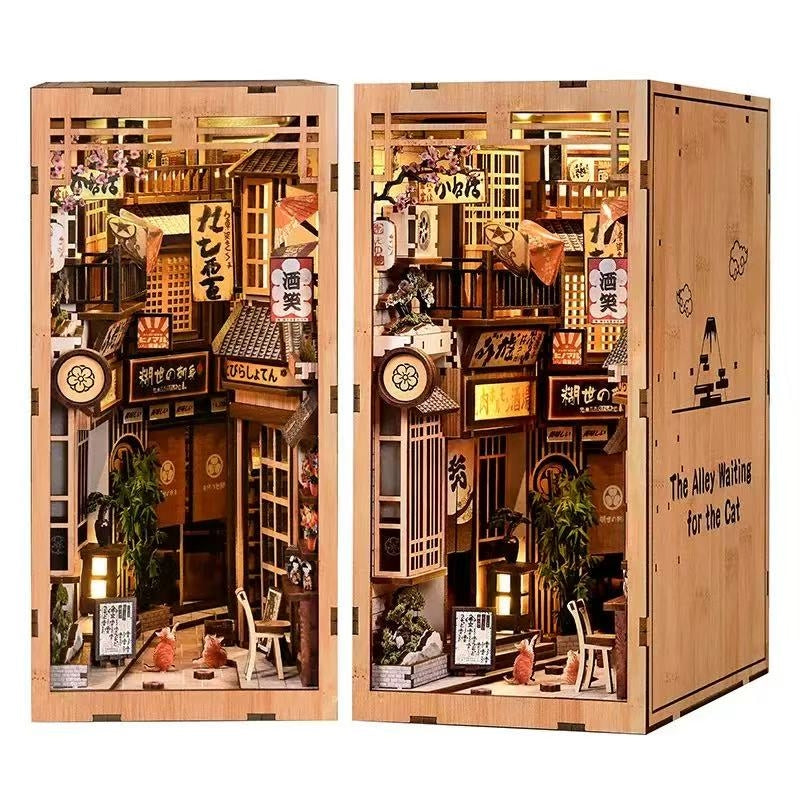 Wooden book nook model of a miniature Japanese street scene with detailed architecture and decorations.