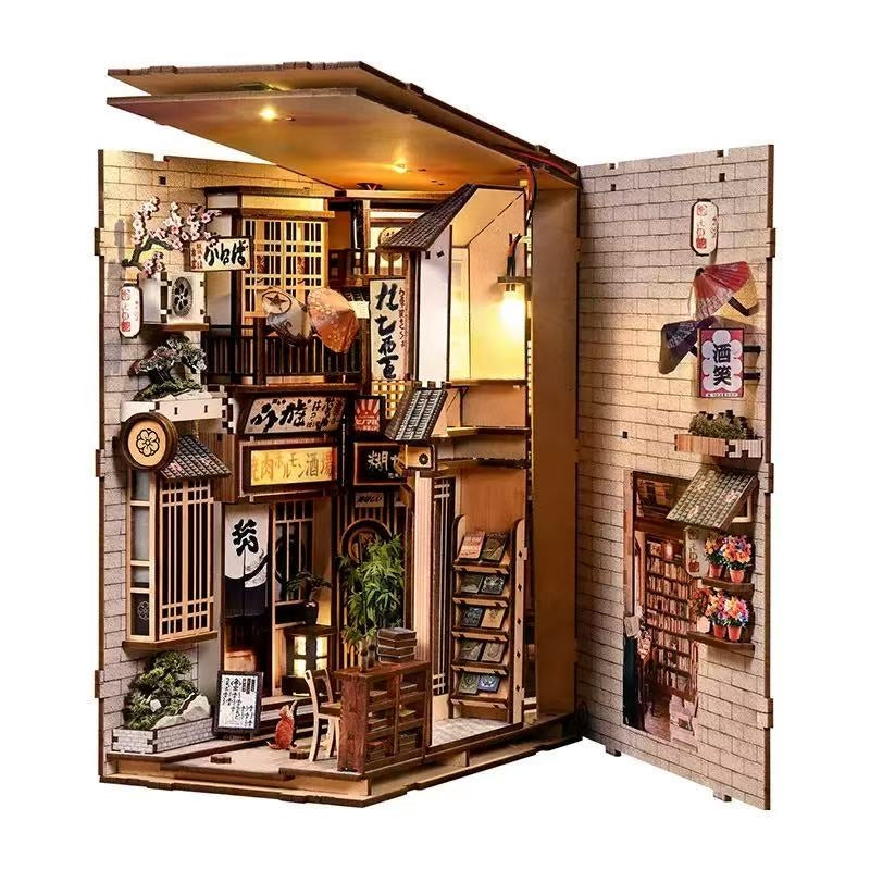 open book nook model of a traditional Japanese street scene with detailed interior decorations on a white background