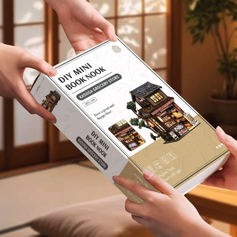 DIY mini book nook packaging held by hands with a traditional Japanese room background