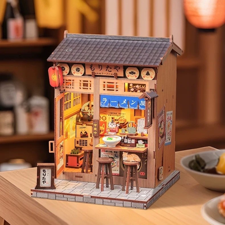 Miniature house model of a Japanese restaurant on a wooden table in a Japanese vibe setting