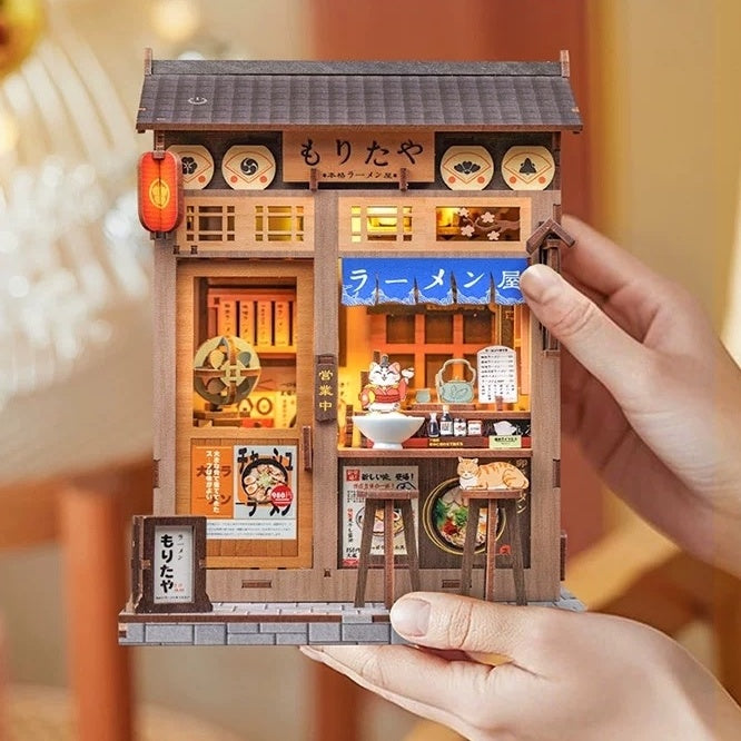 Miniature model of a Japanese ramen shop held by a hand