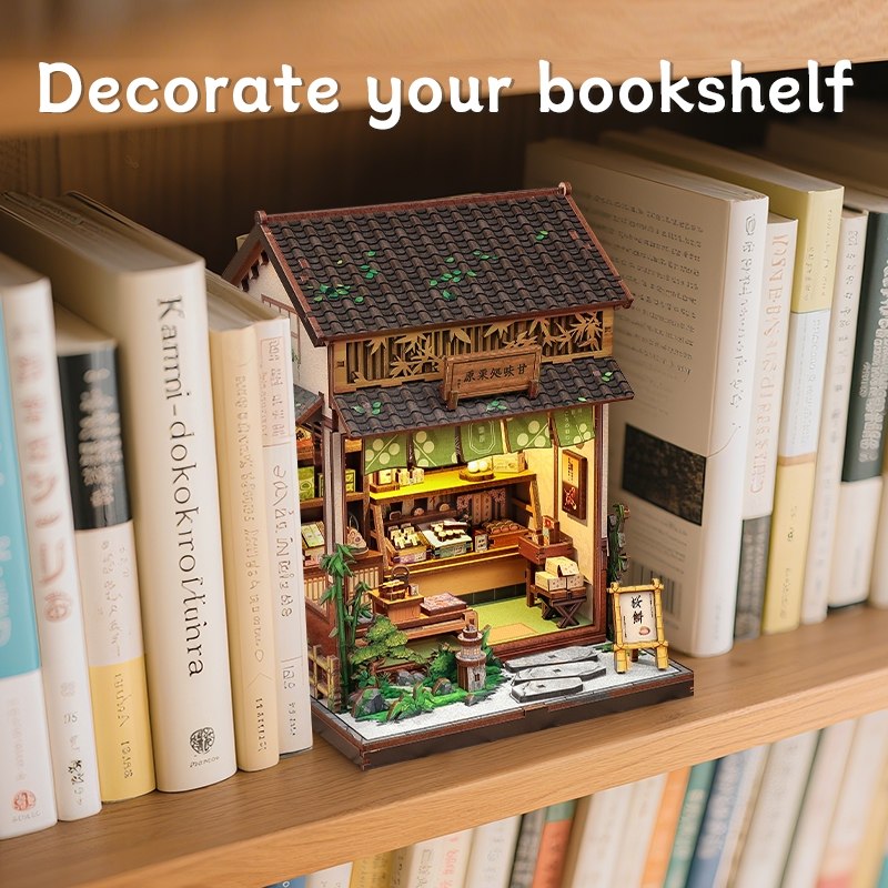 Miniature model of a traditional Japanese tea house on a bookshelf with text 'Decorate your bookshelf'.