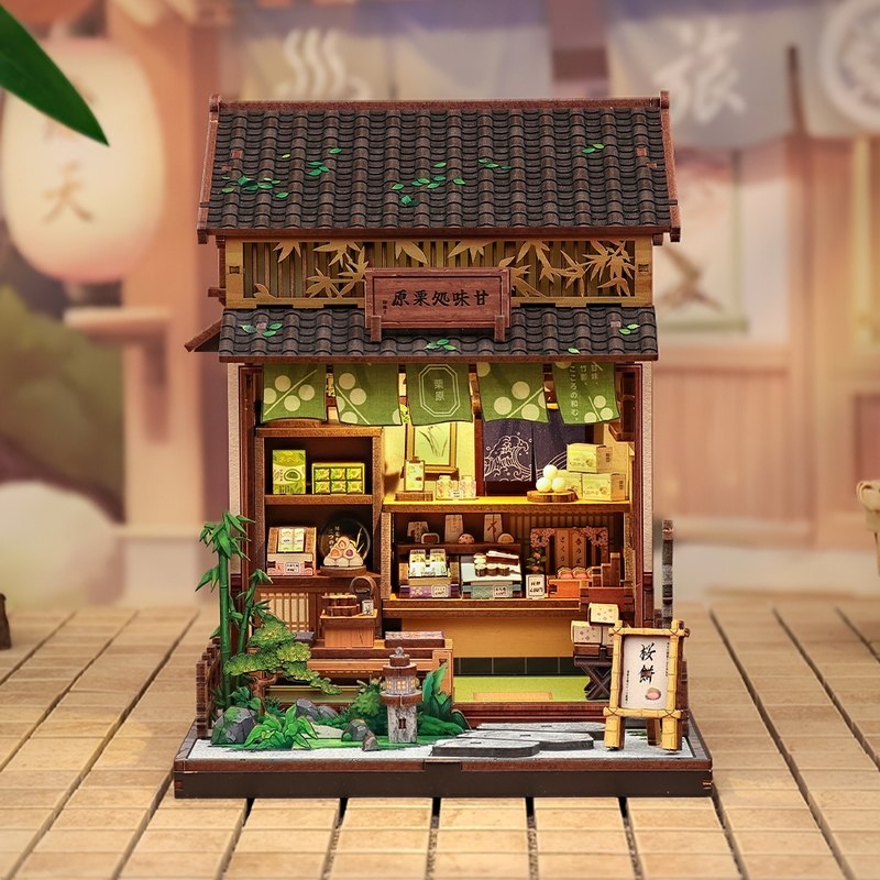 Detailed dollhouse model of a traditional Japanese tea house on a wooden surface.