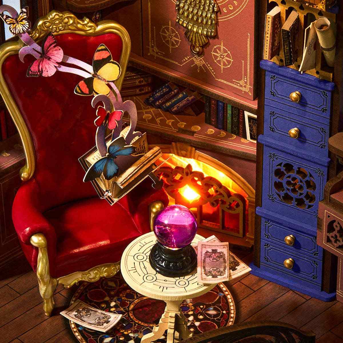 miniature scene with a red chair, blue cabinet, and mystical elements in a magic house book nook
