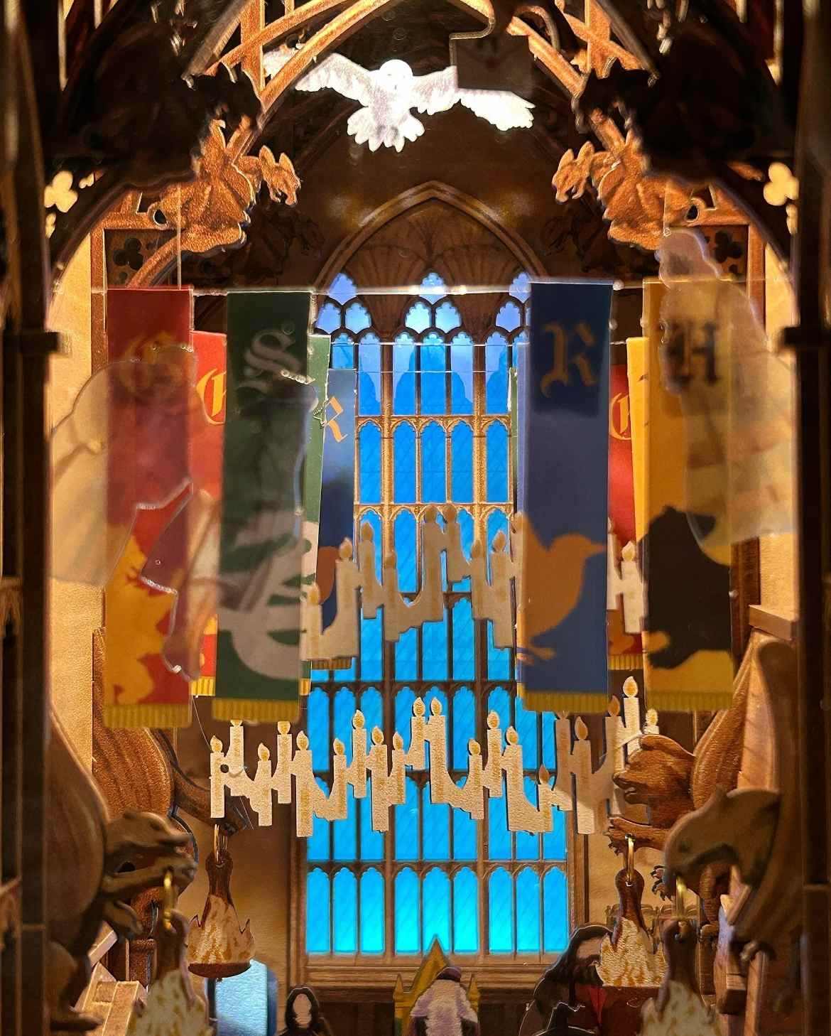 close-up decorative interior with stained glass window and hanging banners in Magic Great Hall Book Nook