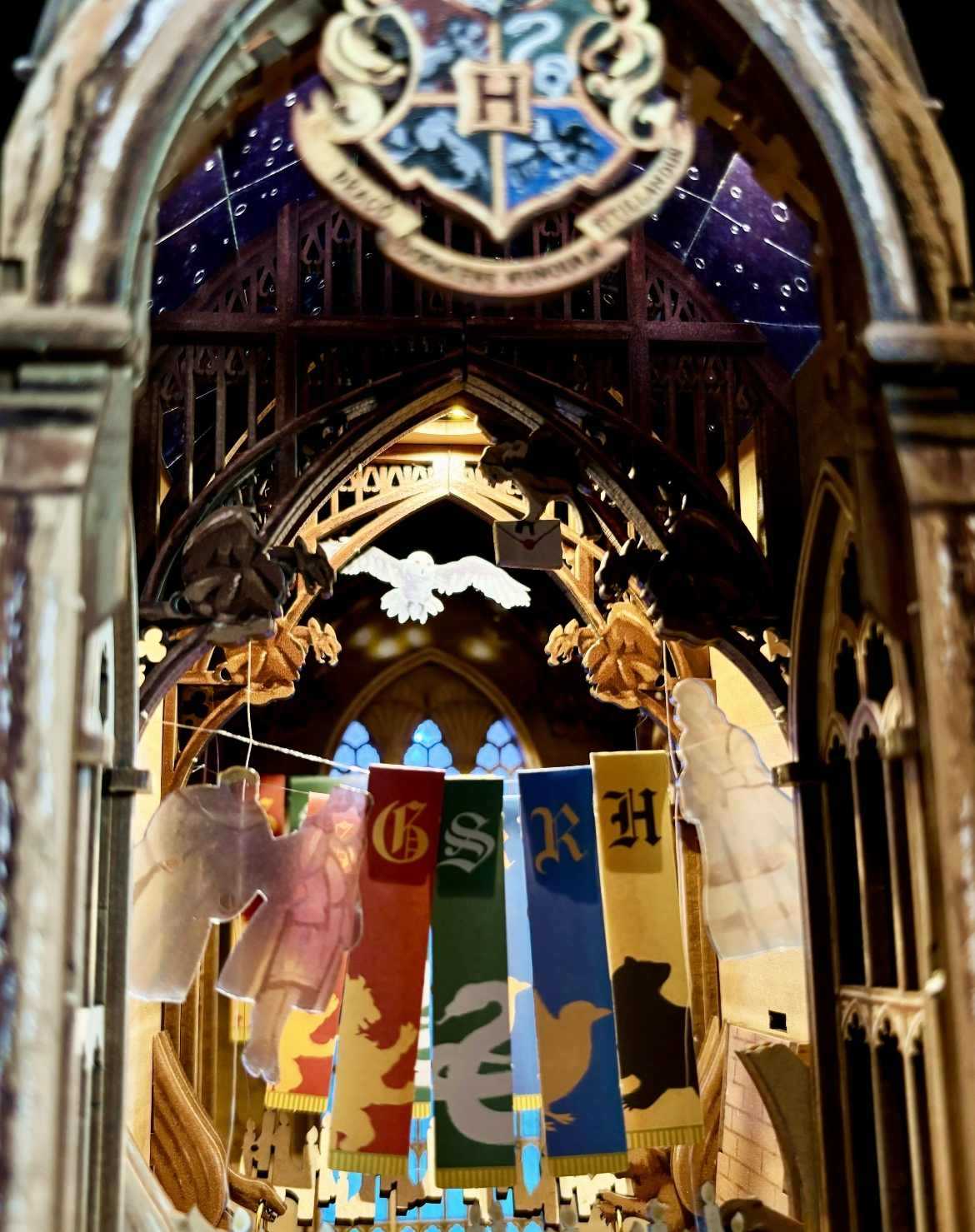 close up the miniature details of decorative archway with Hogwarts house banners in a cathedral setting in Magic Great Hall Book Nook