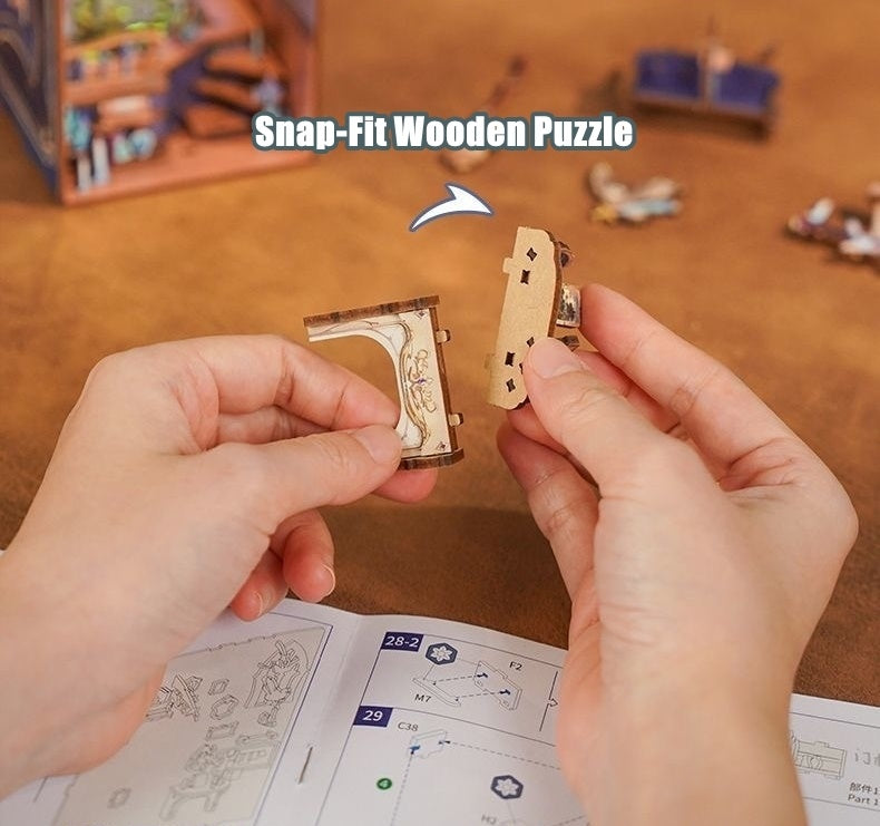 Hands holding a small snap-fit wooden puzzle piece