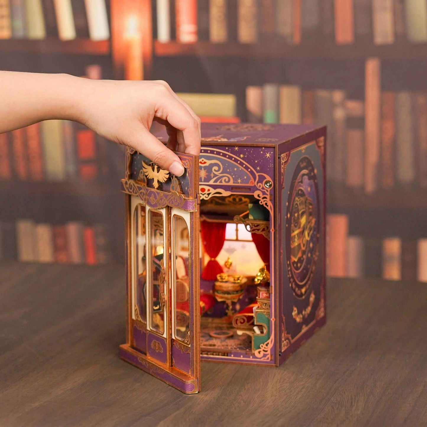 image displaying the magnetic door of Magical Journey Train Cabin DIY Book Nook Kit is open by hand