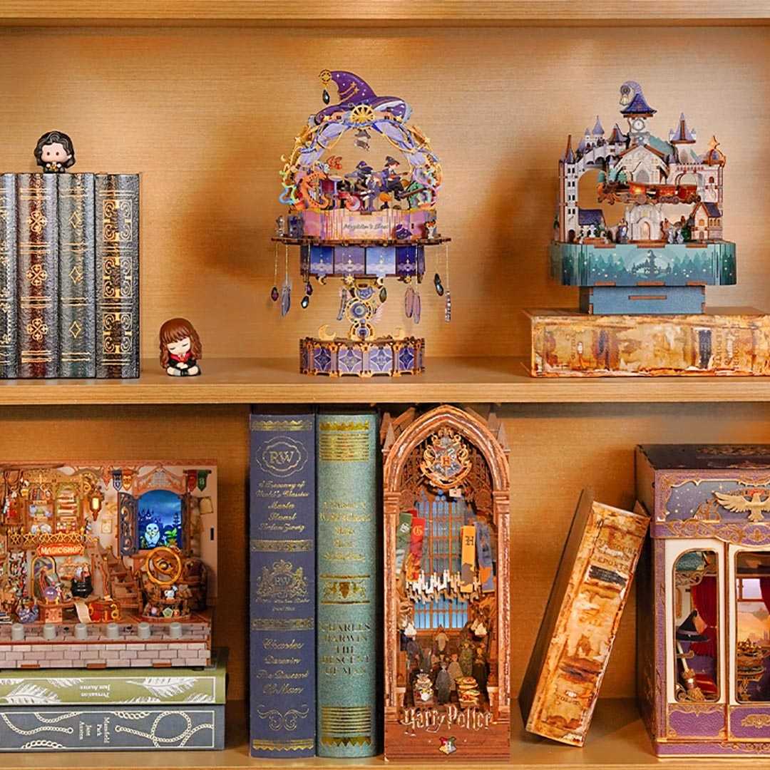 Collection of Harry Potter-themed decorative book nooks and music boxes on a shelf.