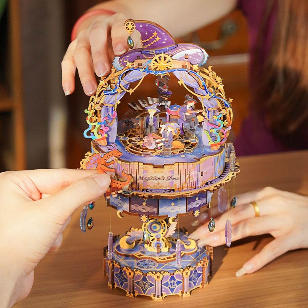 Colorful mechanical Magician's Show wooden music box being assembled by hands