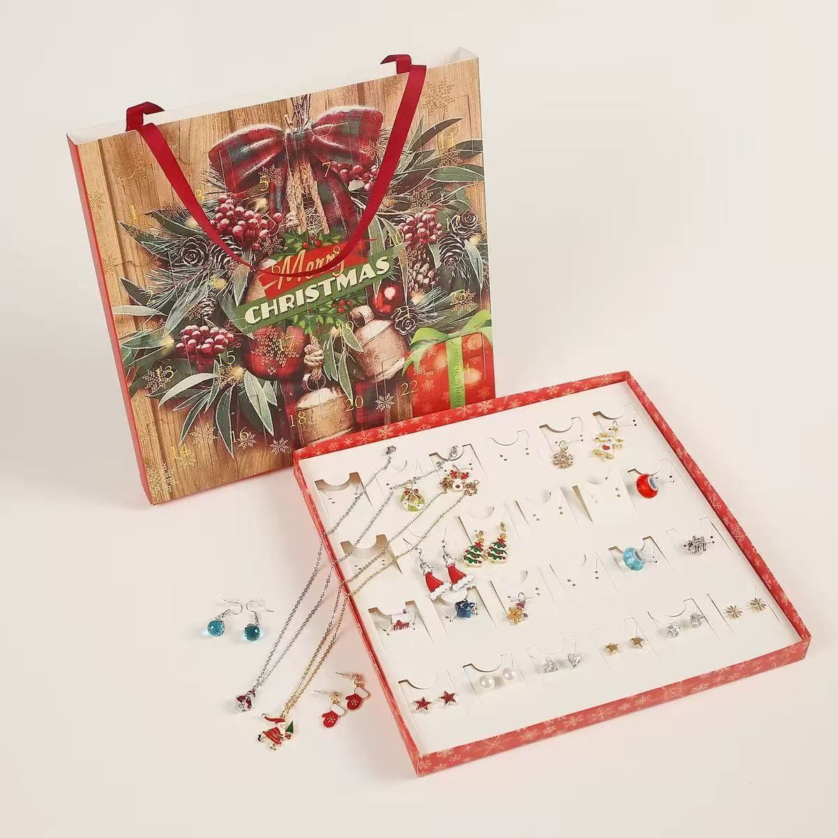 Christmas-themed jewelry set with earrings displayed on a white surface, accompanied by a decorative box.
