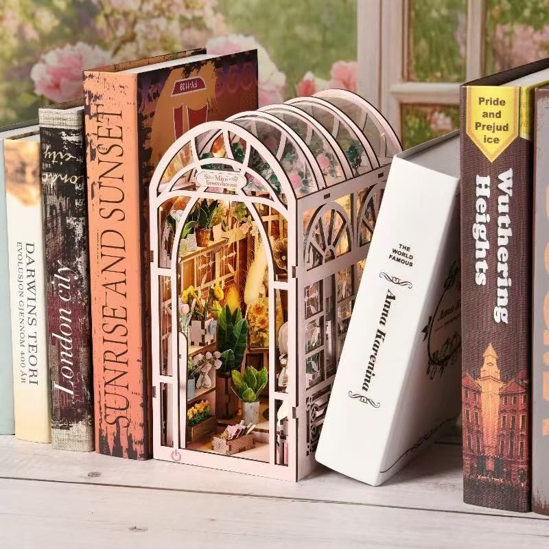 image displaying the finished Mini Greenhouse DIY Book Nook Kit in a bookshelf setting