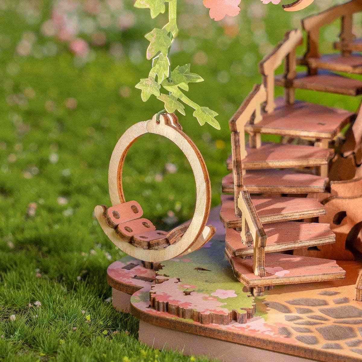 Wooden fairy tale scene with a swing and staircase in Sakura Tree House 3D Wooden Puzzle