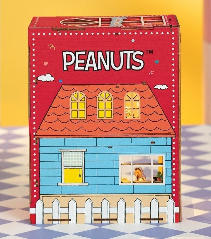 Peanuts-themed wooden book nook house with a red roof and blue body on a yellow background