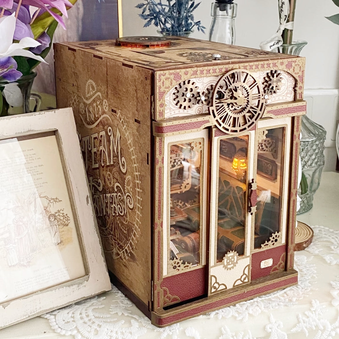 image displaying a side view of Steampunk Fantasy Infinite Train Cabin DIY Book Nook Kit in a vintage table setting
