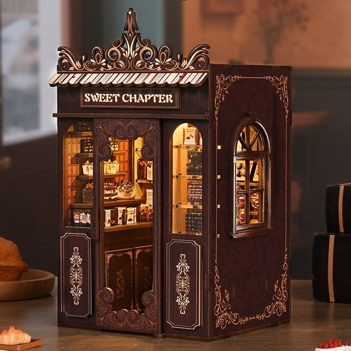 assembled Wooden Book Nook of dessert-shop-themed with warm light on table as a decorative piece
