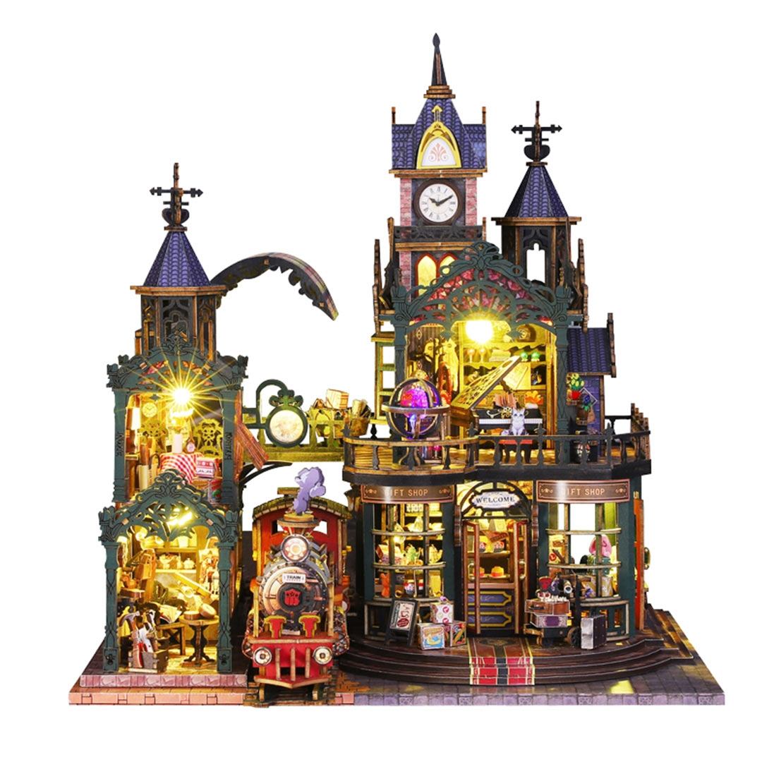 Detailed miniature house model of steampunk railway station with various lit-up features on a white background