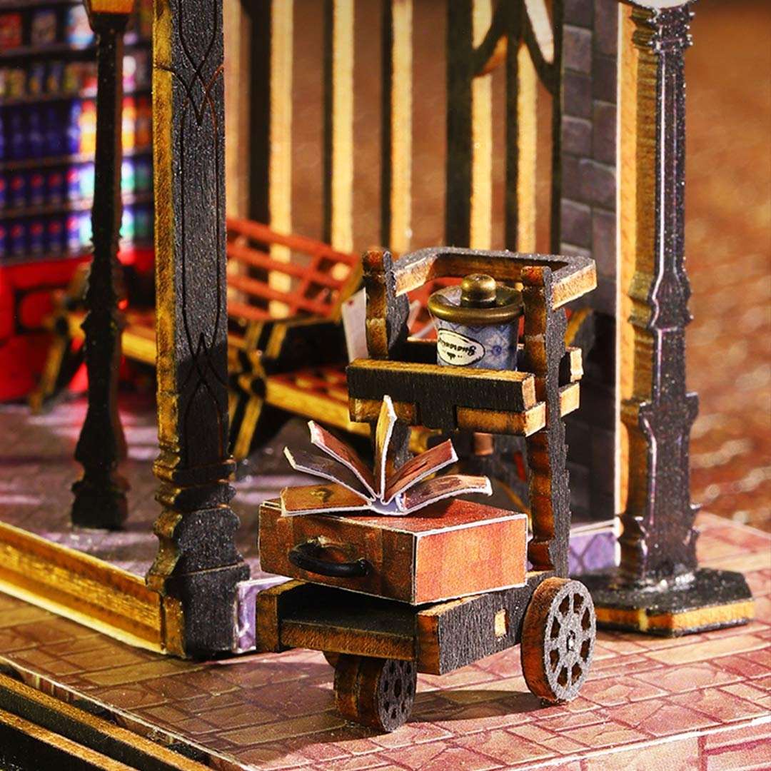 Miniature model of a cart with books and a teapot on a detailed background