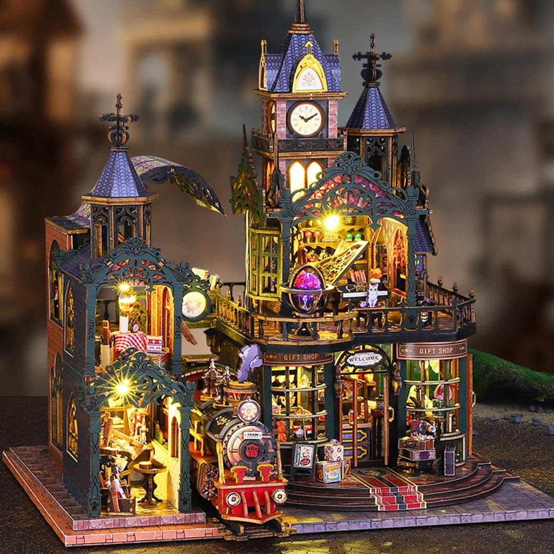 Detailed miniature house model of a retro-futuristic steampunk train station with various elements and lights