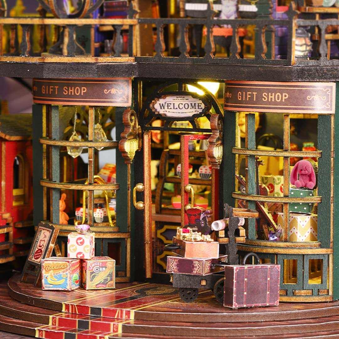 Detailed miniature model of a gift shop with various items and a welcome sign.