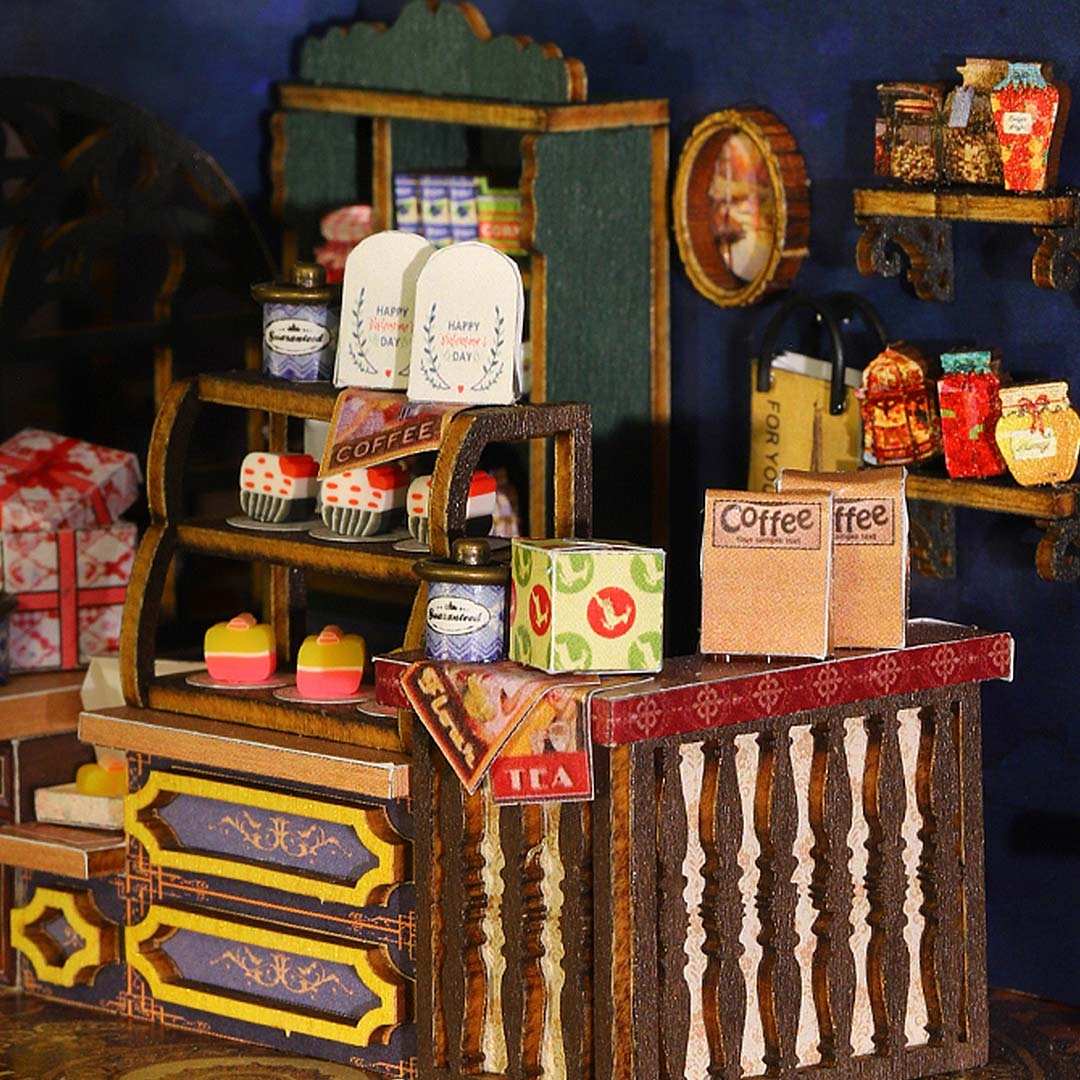 Miniature store display with shelves and products against a dark blue wall.